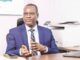 Federal Gov’t Cuts Ministers’ Imprest To N700,000, Tightens Spending Rules Professional man in a blue suit seated at a desk in an office, gesturing with his hands as he speaks.