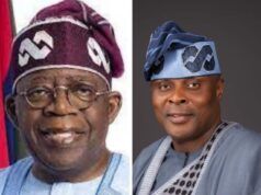 APC Support Groups Council Endorses Tinubu For Second Term On Democracy Day Two Nigerian men in traditional attire posing side by side: the left is an older man with a purple cap and glasses, the right is a younger man in a blue agbada with a matching patterned cap, both smiling.