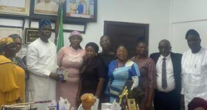 Oyo Govt Backs Women Broadcasters’ Forum, Declares 3-Day Prayer/Fasting For Orire Abductees Group of professionals posing for a photo at an awards ceremony with trophies and certificates on the table in front of them.