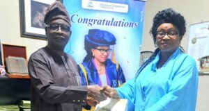Kola Daisi ‘Varsity’s New VC, Prof Morenikeji Receives Copy Of ParrotXtra’s 20th Anniversary Compendium Professor Olajumoke Morenikeji, right, receives the Compendium from Ambassador Olayinka Agboola...in her office...