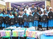 Excitement As Dangote Cement Boosts Learning In Lagos Host Community Group photograph of students and pupils of Ladi-Lak Nursery and Primary Schools and management team of Dangote Cement during the donation of the school items...