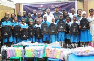 Excitement As Dangote Cement Boosts Learning In Lagos Host Community Group photograph of students and pupils of Ladi-Lak Nursery and Primary Schools and management team of Dangote Cement during the donation of the school items...